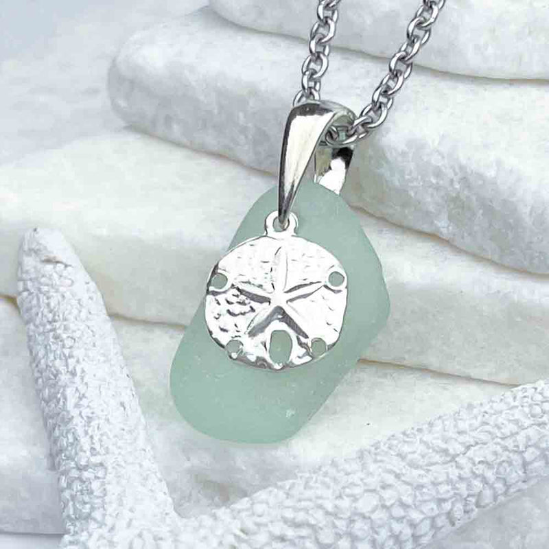 This Crisp Ice Aqua Sea Glass Pendant Pairs Beautifully with a Sand Dollar Charm|View the entire collection of guaranteed authentic Sea Glass! Real Sea Glass Necklaces | Bracelets | Earrings | Rings | Rare Colors Our Specialty | 30+ Years Experience