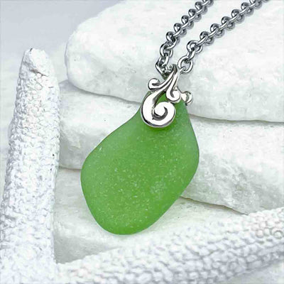 Get Swept Away to Distant Shores by this Wave-shaped Glowing Green Sea Glass Pendant | View the entire collection of guaranteed authentic Sea Glass | Real Sea Glass Necklaces|Bracelets |Earrings |Rings|Rare Colors Our Specialty |30+ Years Experience