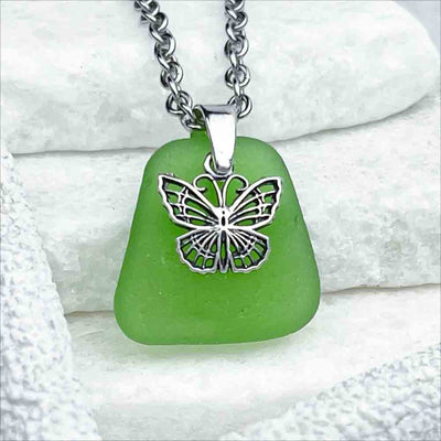 This Playful Green Sea Glass Pendant is Topped with a Delightful Butterfly Charm  | View the entire collection of guaranteed authentic Sea Glass| Real Sea Glass Necklaces| Bracelets| Earrings| Rings| Rare Colors Our Specialty| 30+ Years Experience 