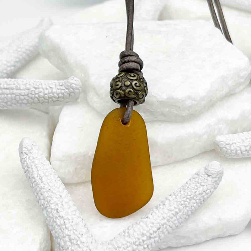 Amber Sea Glass Leather Necklace with a Detailed Bronze Bead 