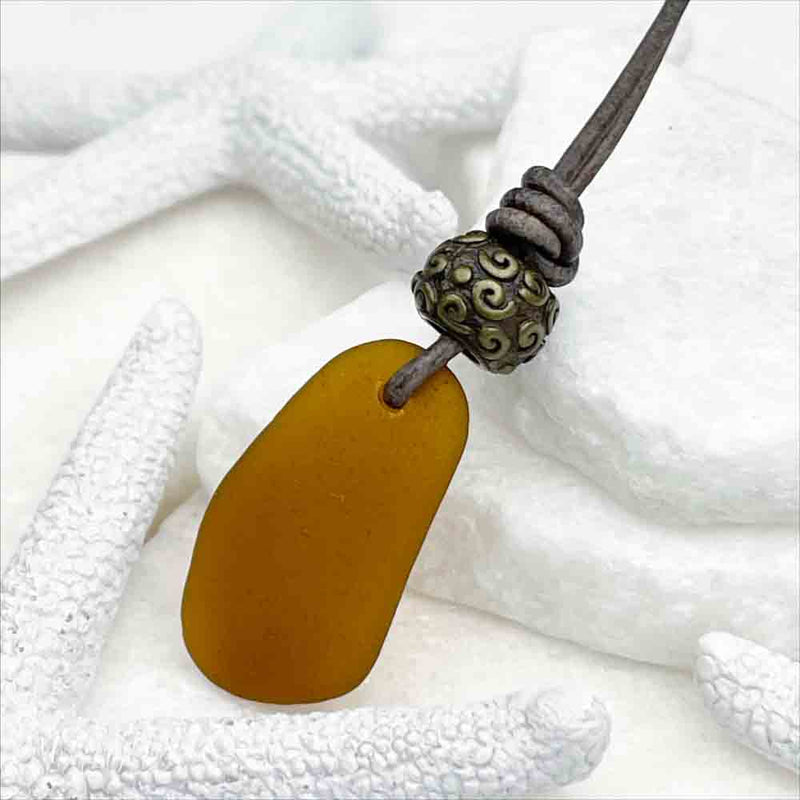 Amber Sea Glass Leather Necklace with a Detailed Bronze Bead 